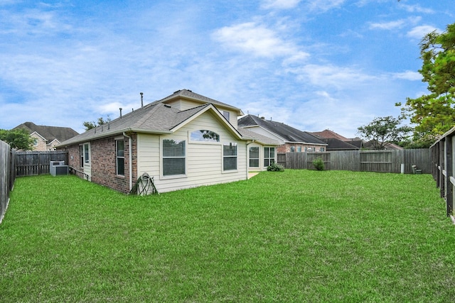 back of property with a lawn