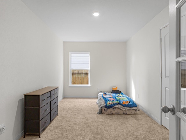 bedroom featuring light carpet