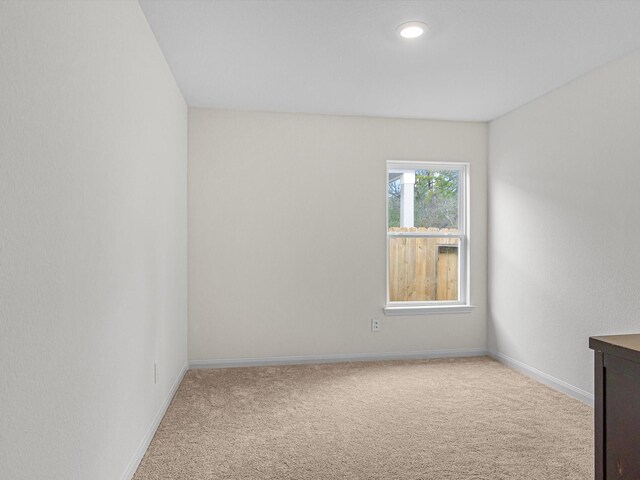 spare room with light carpet