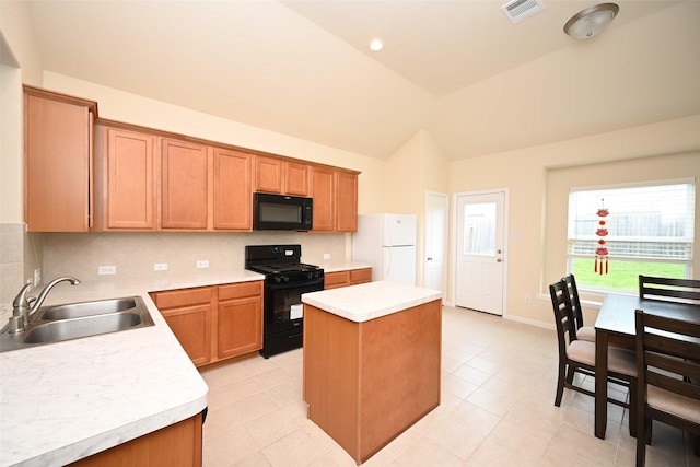 kitchen featuring a center island, black appliances, sink, vaulted ceiling, and tasteful backsplash