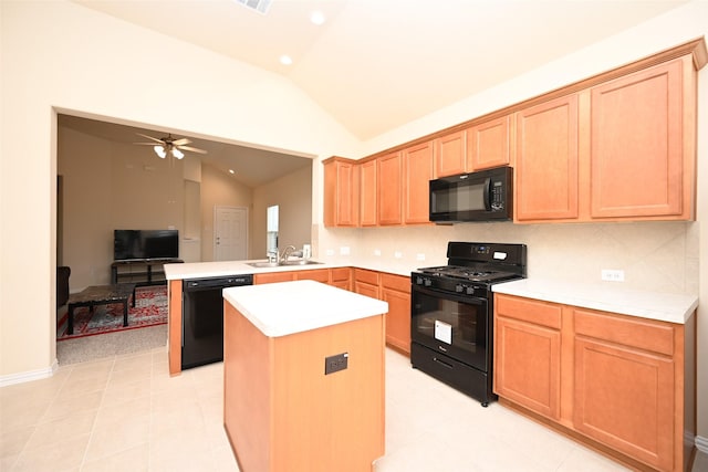 kitchen featuring kitchen peninsula, decorative backsplash, ceiling fan, sink, and black appliances