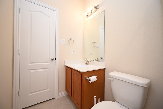 bathroom featuring tile patterned floors, vanity, and toilet