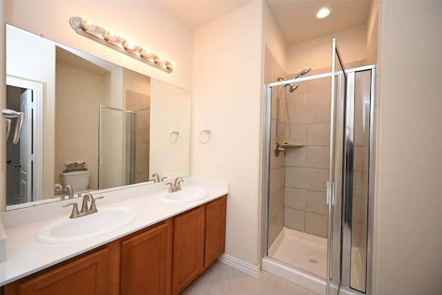 bathroom featuring walk in shower, tile patterned flooring, vanity, and toilet