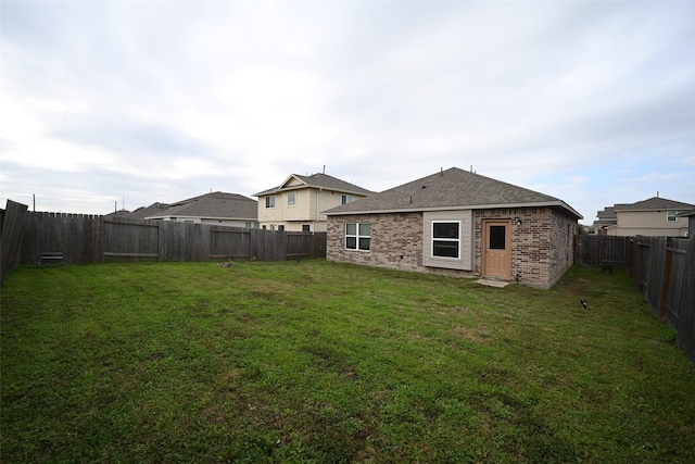 rear view of property with a yard