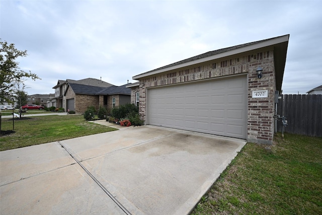 ranch-style home with a garage and a front yard