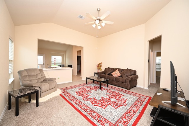 carpeted living room featuring ceiling fan and lofted ceiling