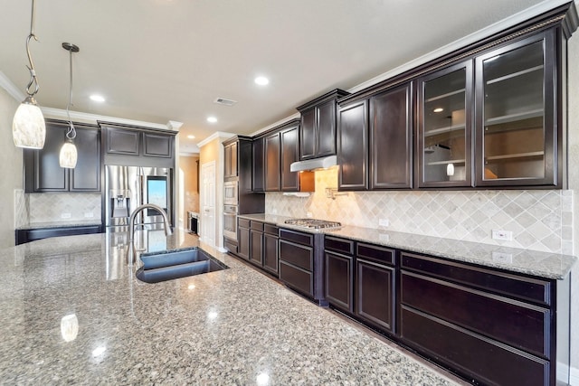 kitchen with sink, hanging light fixtures, stainless steel appliances, crown molding, and dark brown cabinets