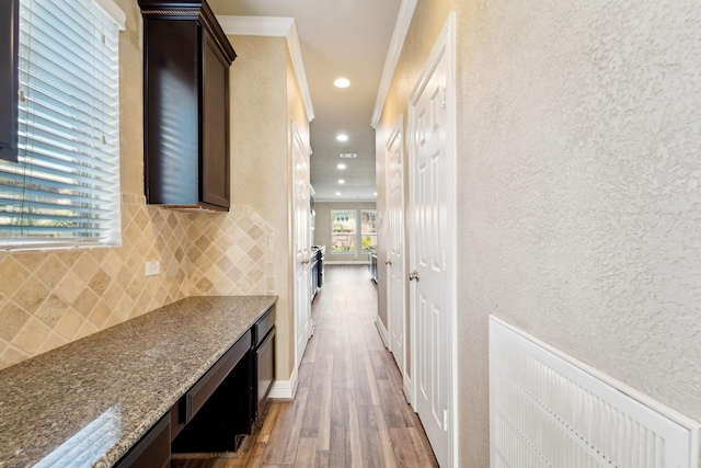 corridor with crown molding and hardwood / wood-style floors