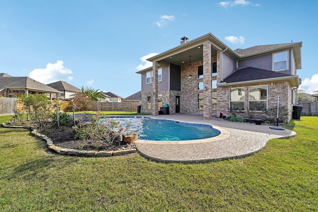 view of pool featuring a patio area and a yard