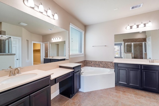 bathroom featuring tile patterned flooring, vanity, and separate shower and tub