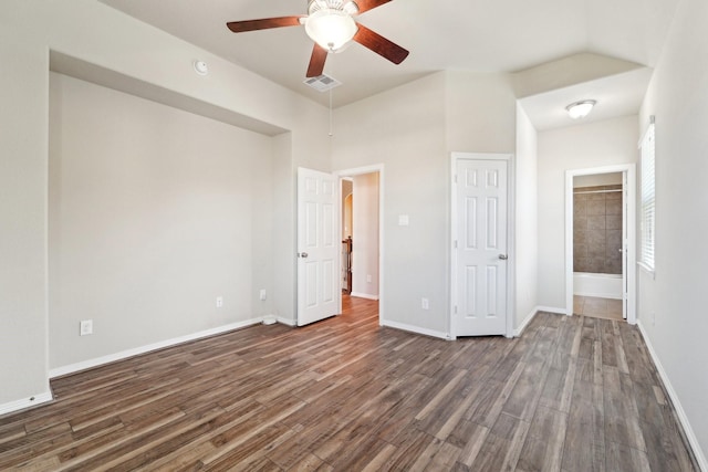 unfurnished bedroom with ceiling fan, dark hardwood / wood-style floors, and ensuite bath