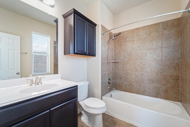 full bathroom with vanity, tile patterned floors, tiled shower / bath combo, and toilet