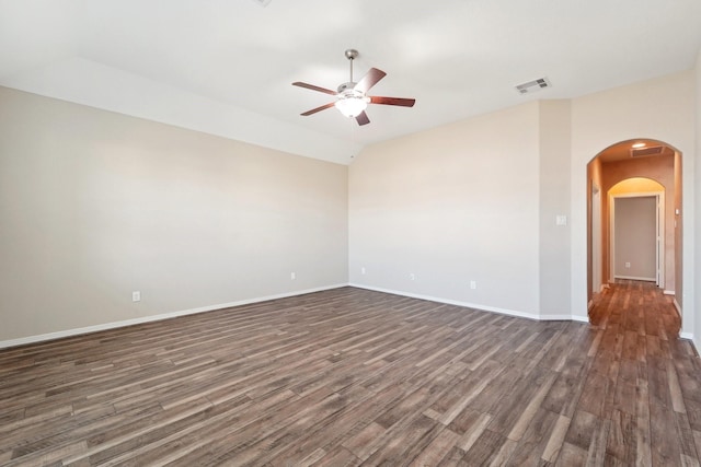 empty room with dark hardwood / wood-style floors, ceiling fan, and lofted ceiling