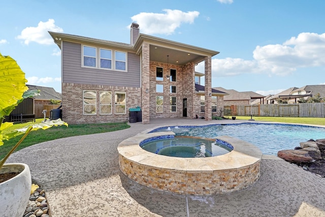 view of pool featuring an in ground hot tub