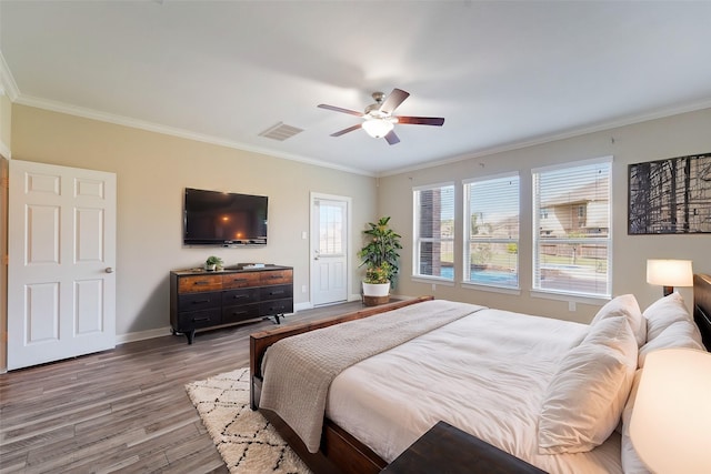 bedroom featuring ceiling fan, ornamental molding, and light wood-type flooring