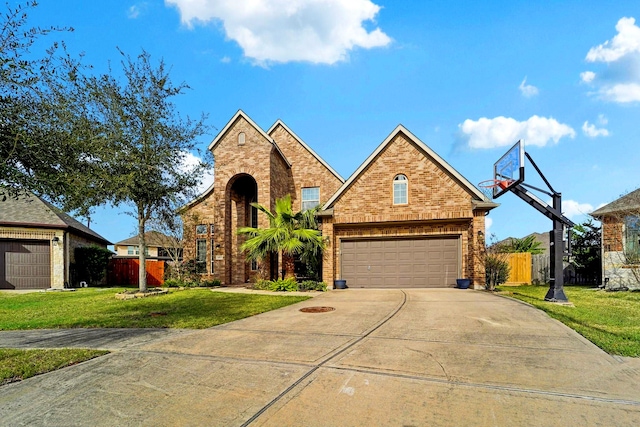 view of front of property with a garage and a front lawn