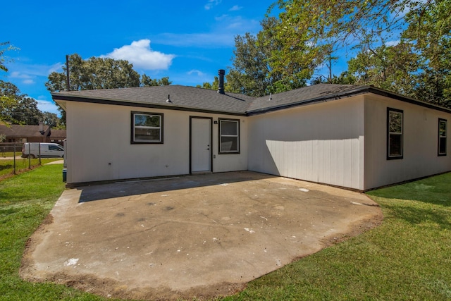 view of front of home with a front yard and a patio