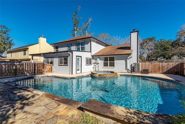 view of pool with an in ground hot tub, a patio area, and cooling unit