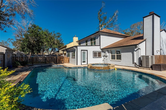 view of pool featuring an in ground hot tub and cooling unit