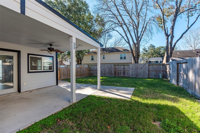 view of yard with ceiling fan and a patio area