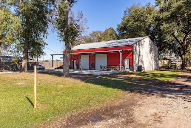 view of outbuilding featuring a garage and a lawn