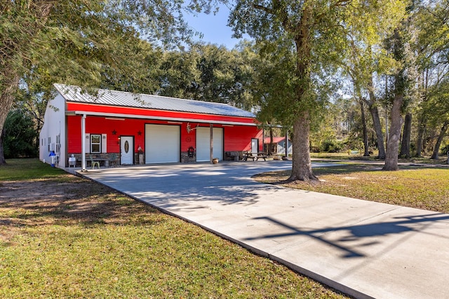 view of front of home featuring a garage and a front lawn