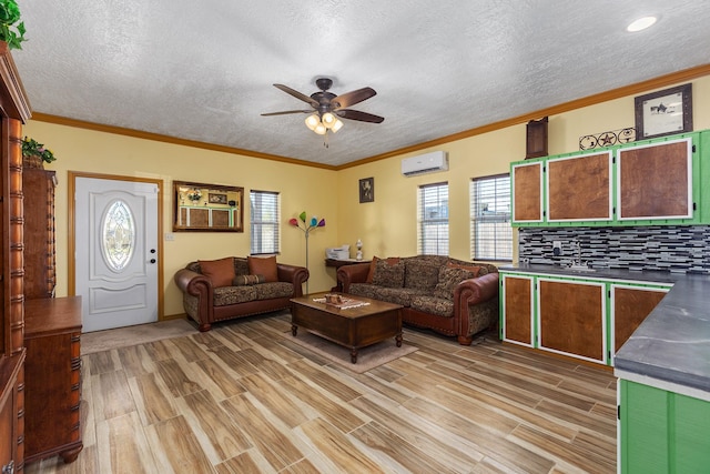 living room with a healthy amount of sunlight, a wall mounted AC, and crown molding