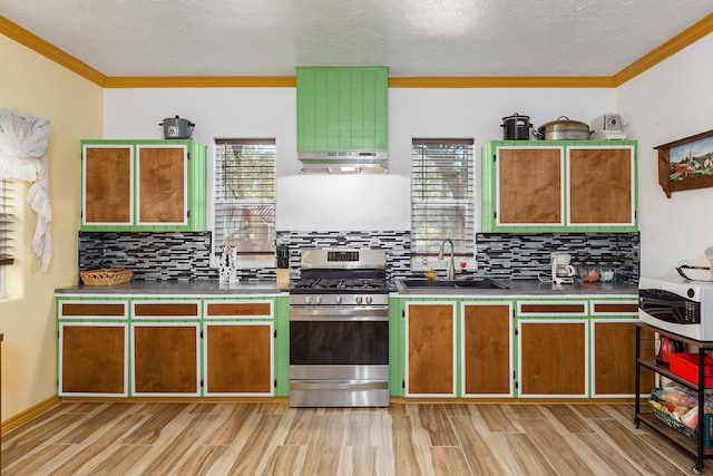 kitchen with stainless steel gas stove, sink, range hood, light hardwood / wood-style floors, and ornamental molding