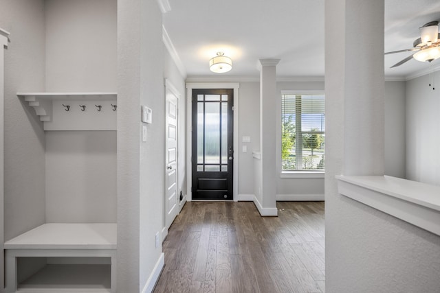 entryway with dark hardwood / wood-style floors, ceiling fan, and ornamental molding