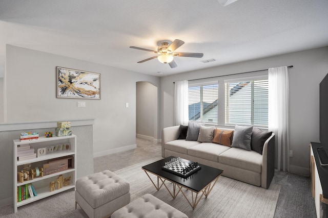 living room featuring light carpet and ceiling fan