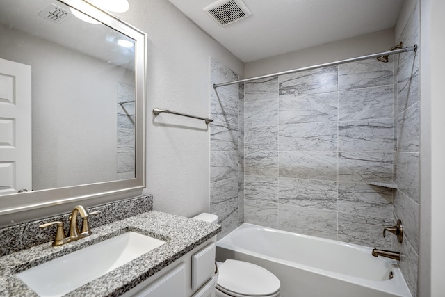 full bathroom featuring vanity, toilet, and tiled shower / bath