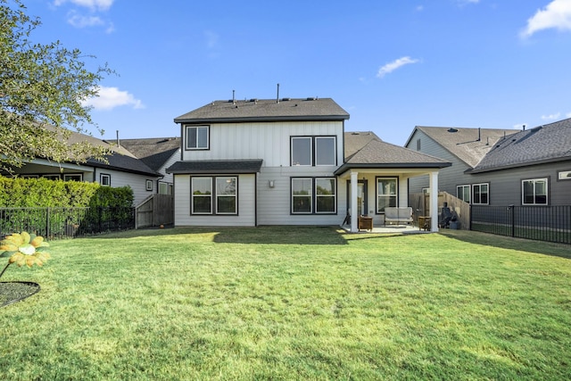 back of property with a yard and a patio