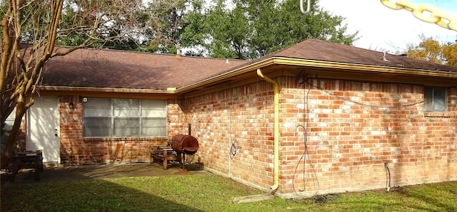 view of side of property with a lawn