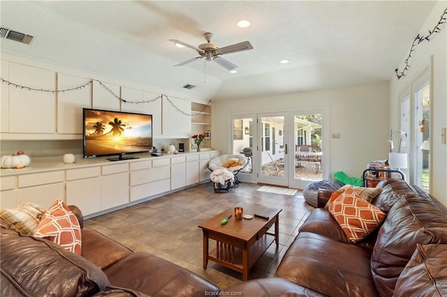 living room with ceiling fan, lofted ceiling, built in shelves, and french doors