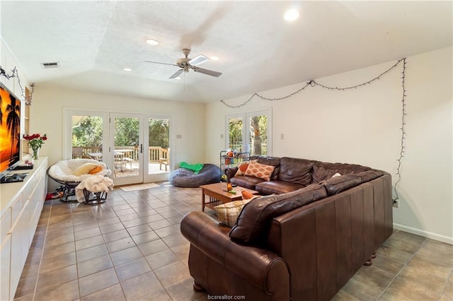 tiled living room featuring ceiling fan, lofted ceiling, and french doors