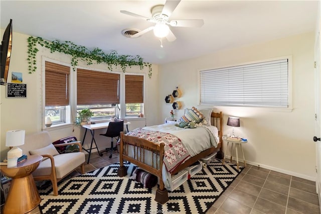 tiled bedroom featuring ceiling fan