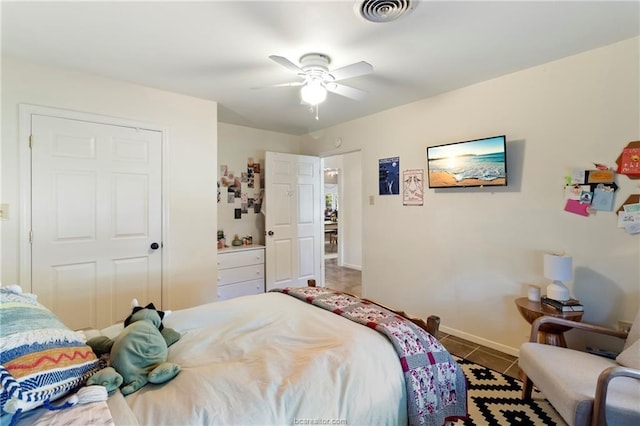 bedroom with tile patterned flooring and ceiling fan