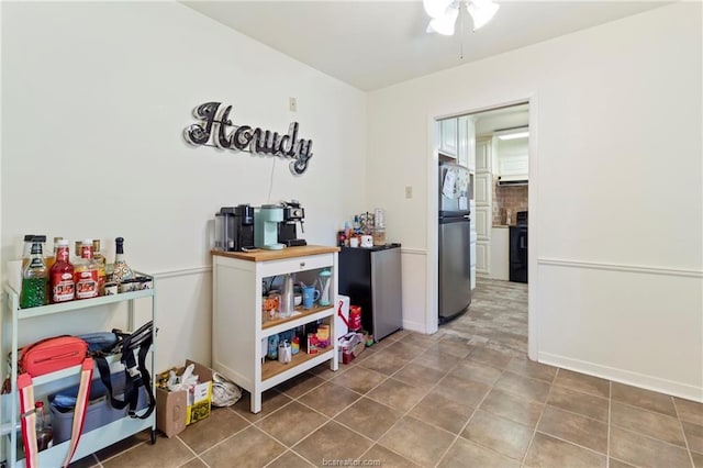 interior space featuring electric range, ceiling fan, and stainless steel fridge