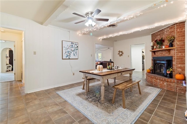 dining area with ceiling fan and beam ceiling