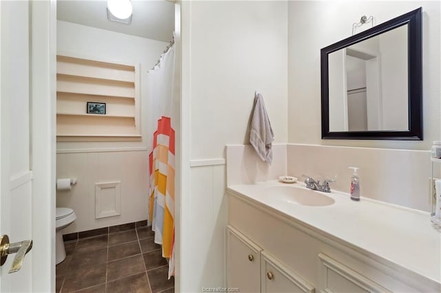 bathroom with tile patterned flooring, vanity, and toilet