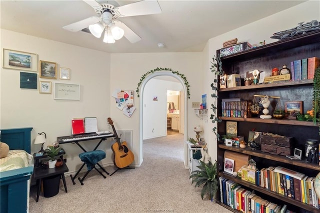 misc room featuring light colored carpet and ceiling fan