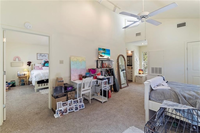 carpeted bedroom with rail lighting, high vaulted ceiling, and ceiling fan