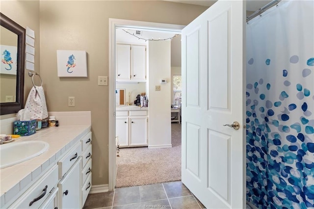 bathroom featuring tile patterned floors, vanity, and curtained shower