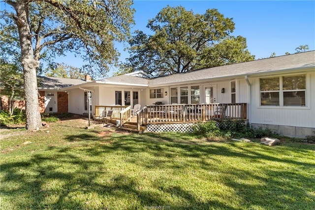 rear view of property featuring a yard