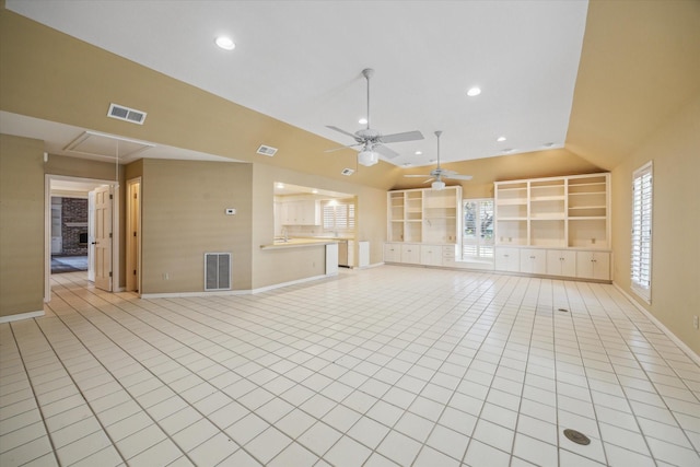 unfurnished living room with a wealth of natural light, ceiling fan, lofted ceiling, and light tile patterned flooring