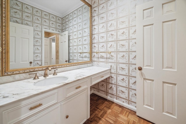 bathroom featuring vanity, parquet floors, and ornamental molding