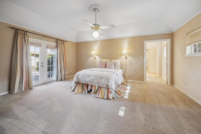 carpeted bedroom featuring access to outside, french doors, a raised ceiling, vaulted ceiling, and ceiling fan