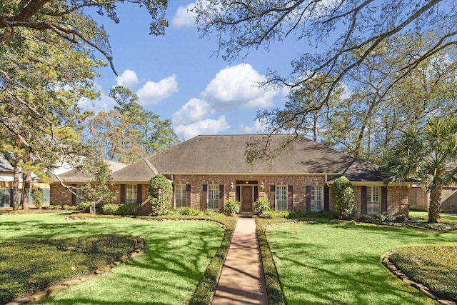 ranch-style home with a front lawn