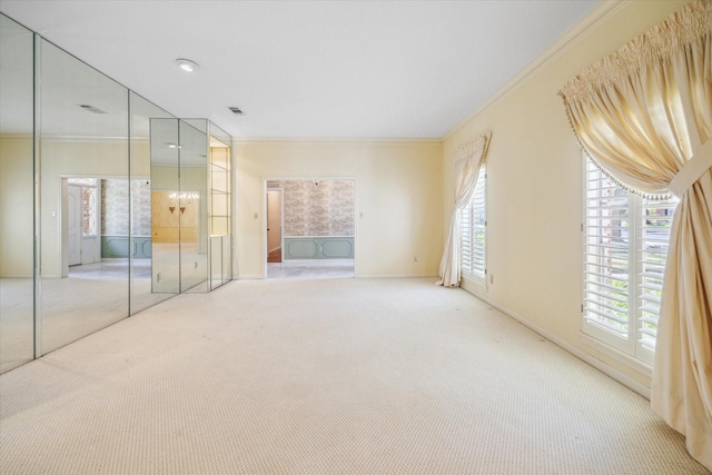 unfurnished bedroom with light colored carpet and ornamental molding