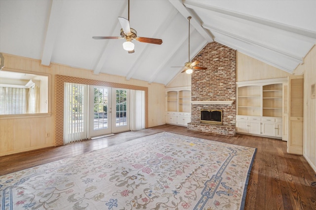 unfurnished living room featuring ceiling fan, french doors, a brick fireplace, built in features, and dark hardwood / wood-style floors